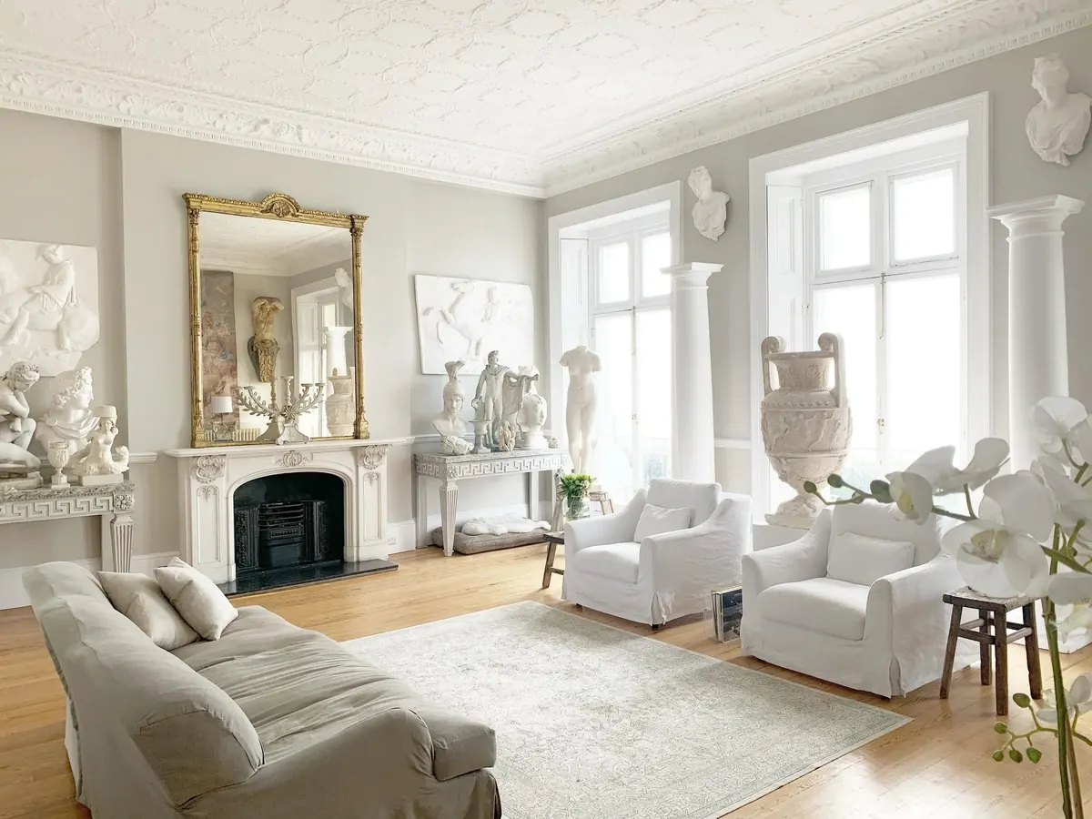 A period drawing room in Brighton furnished with an antique collection, gilt mirror and classical casts