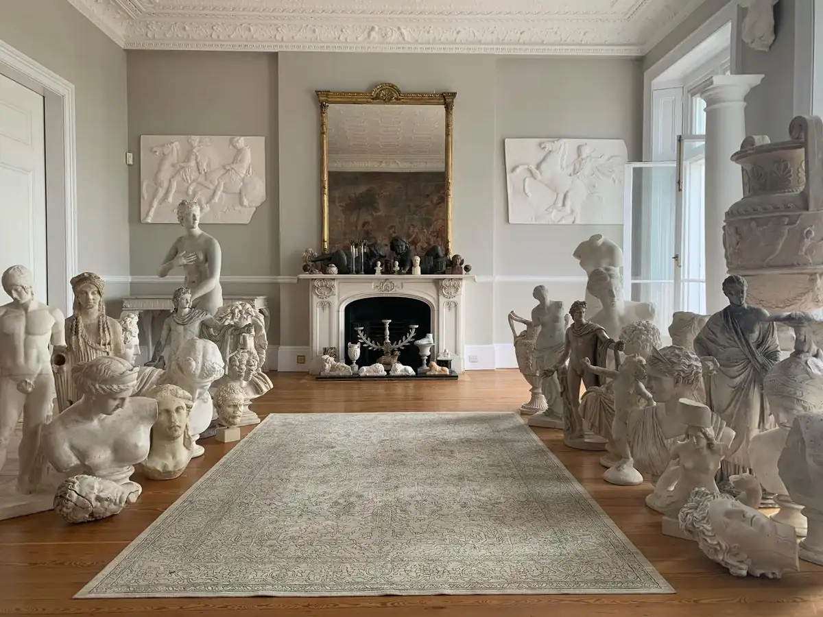 Classical busts and sculpture placed around a period drawing room after an antiques move