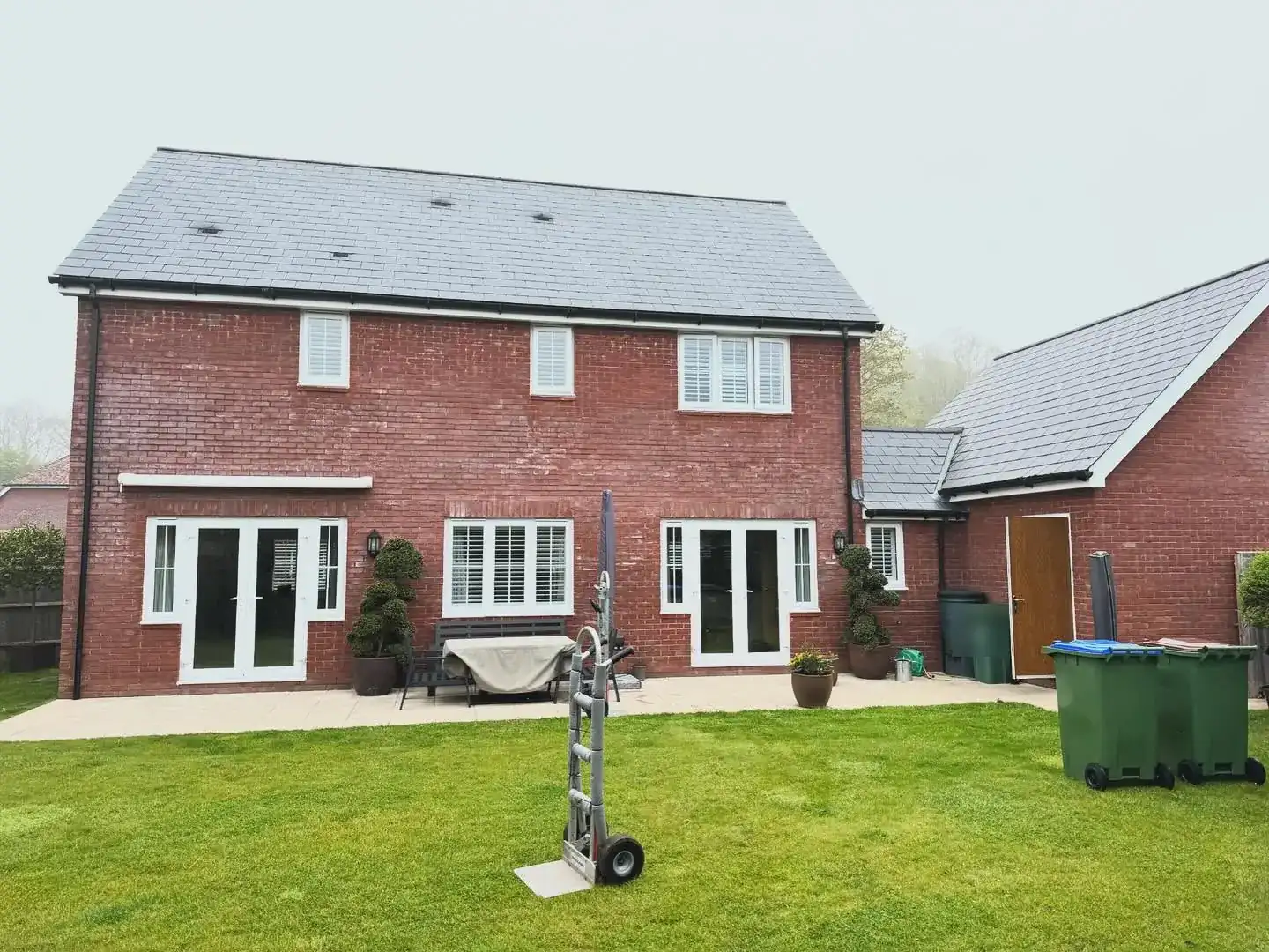 The rear of a red-brick house in Billingshurst, West Sussex, on the morning of a long-distance removal
