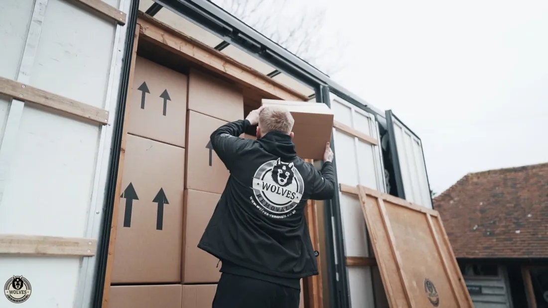A Wolves Removals crew member carefully loading boxes on moving day