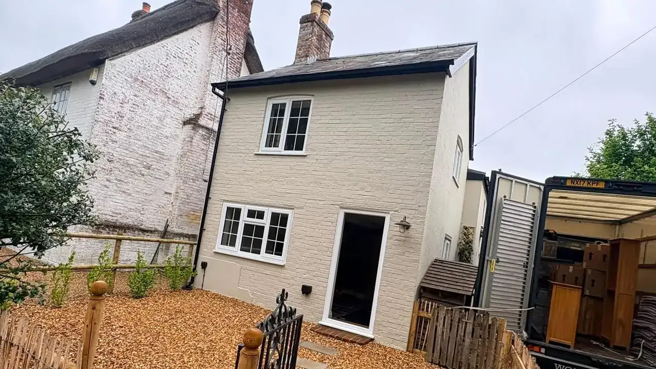 A Wolves Removals lorry loaded beside a period cottage at the end of a Chichester move