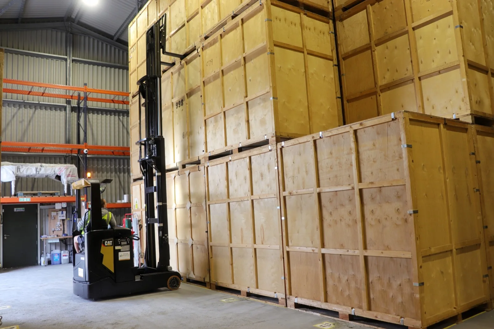 Wooden storage containers stacked inside the Wolves Removals warehouse