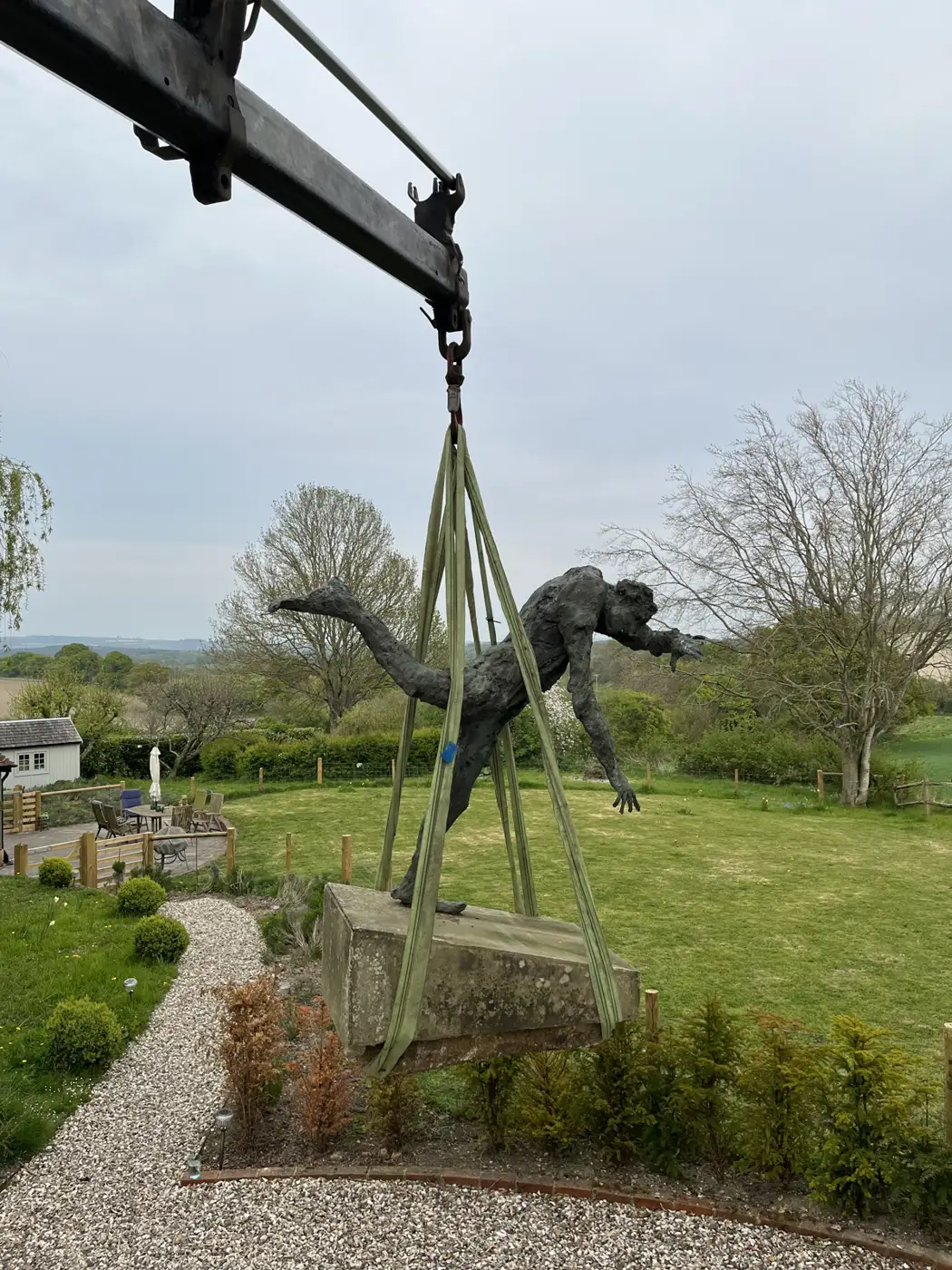 HIAB crane lifting a large garden statue during a move in Falmer, East Sussex