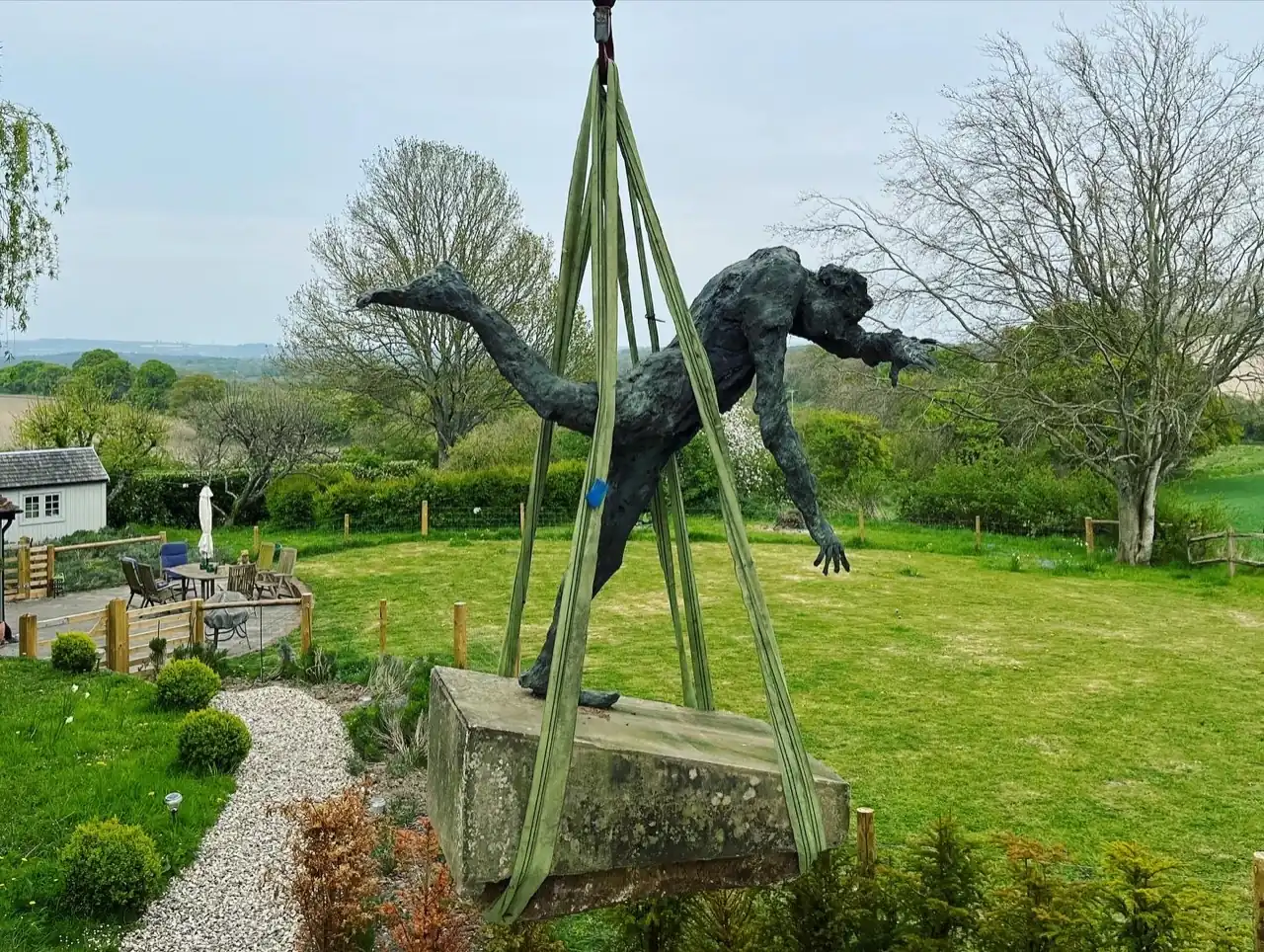 Craning a bronze statue in a garden in Horsham