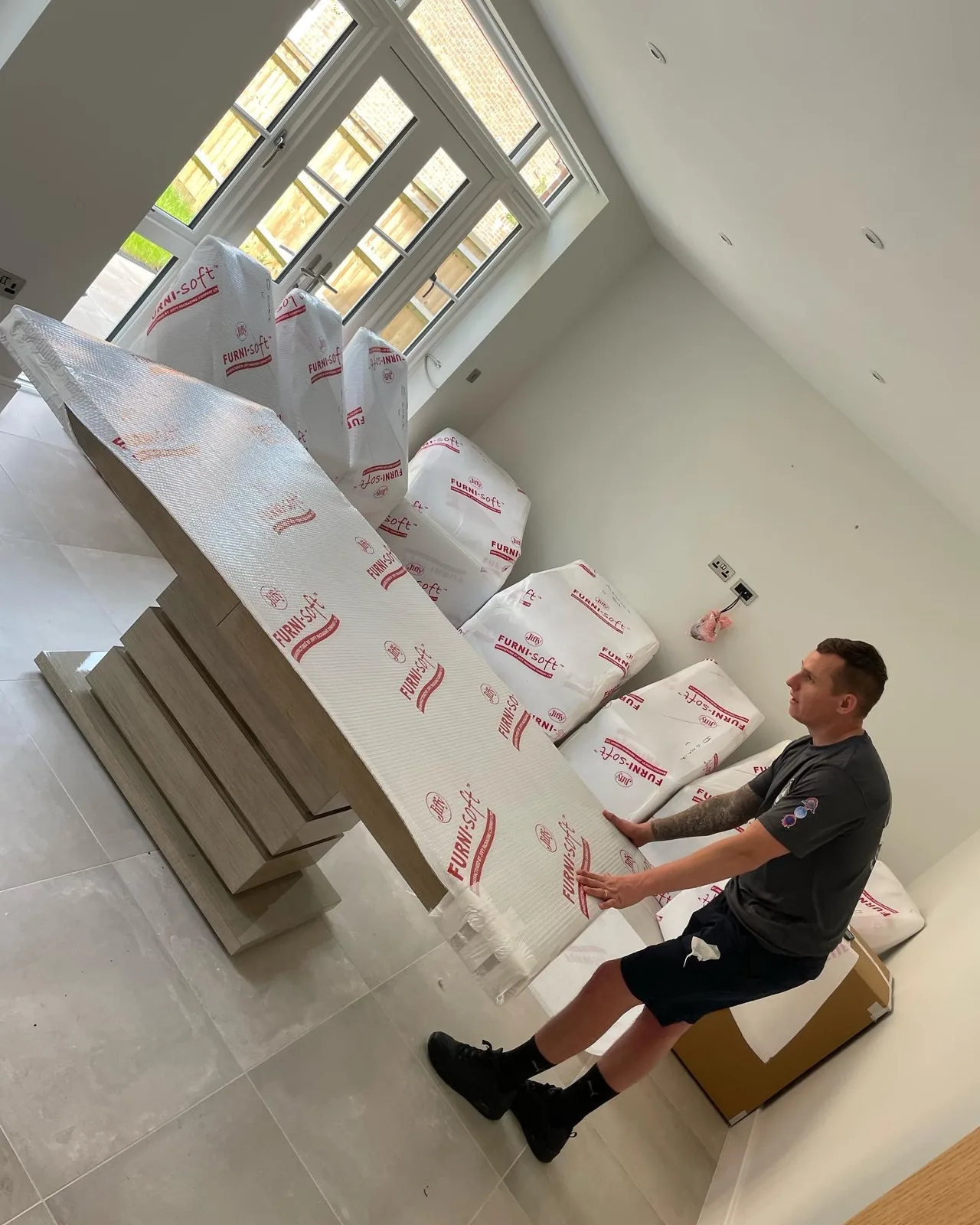 Wolves Removals crew working with wrapped furniture