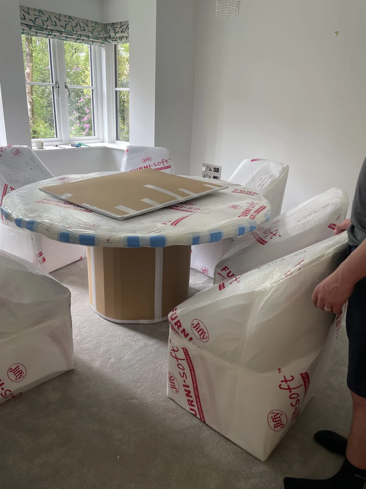 Crew with wrapped furniture and boxes on a Pulborough house move