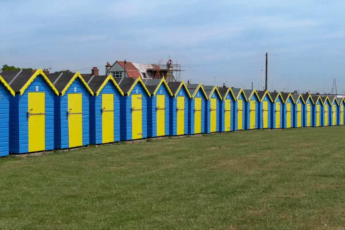 Row of colourful beach huts along the seafront at Felpham near Bognor Regis