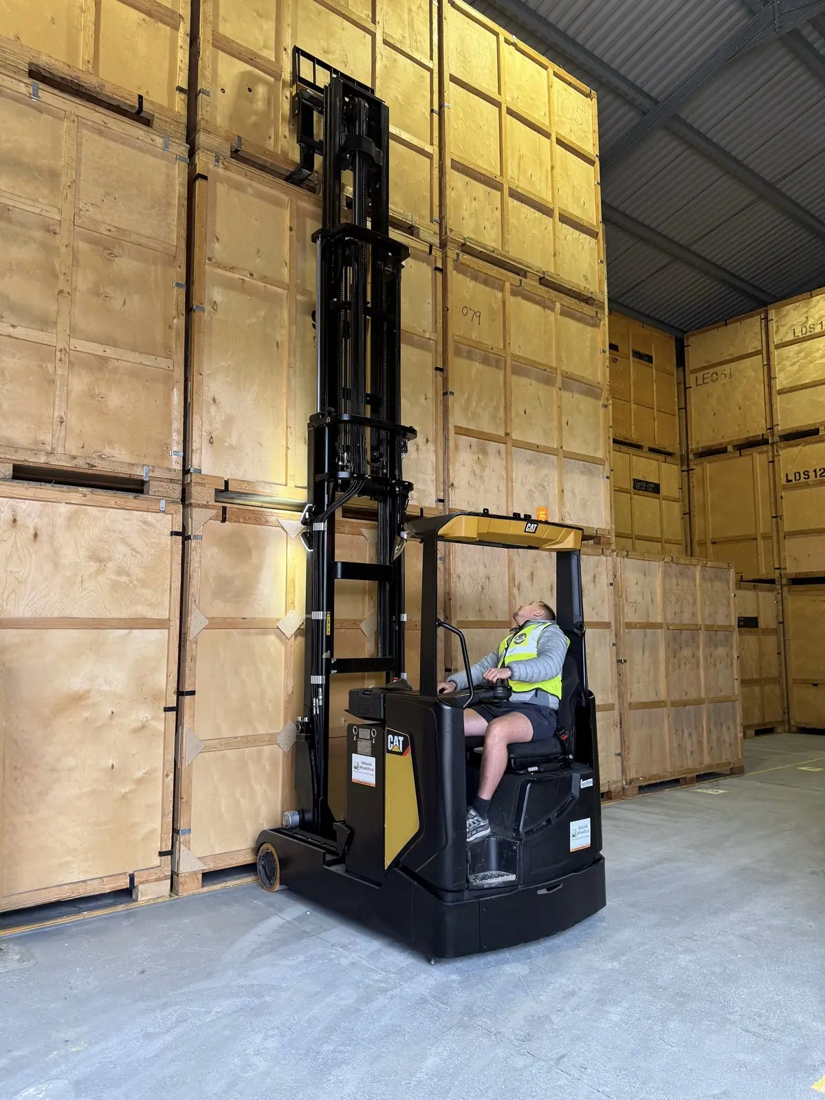 Forklift stacking storage containers warehouse