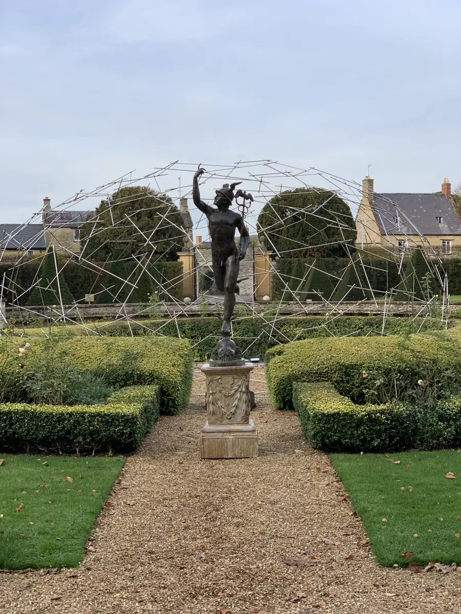 Formal stately-home garden with a winged statue