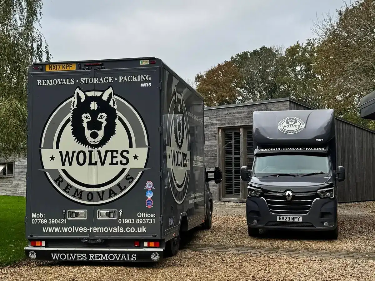 Two Wolves Removals lorries loaded on the driveway during a house move near Horsham
