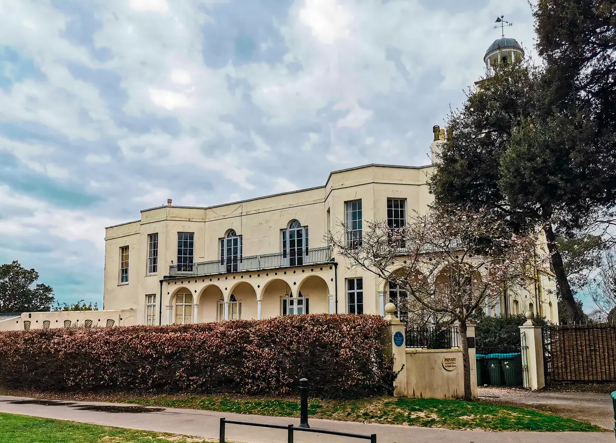 Hotham Park House and its clock tower seen from the park path in Bognor Regis