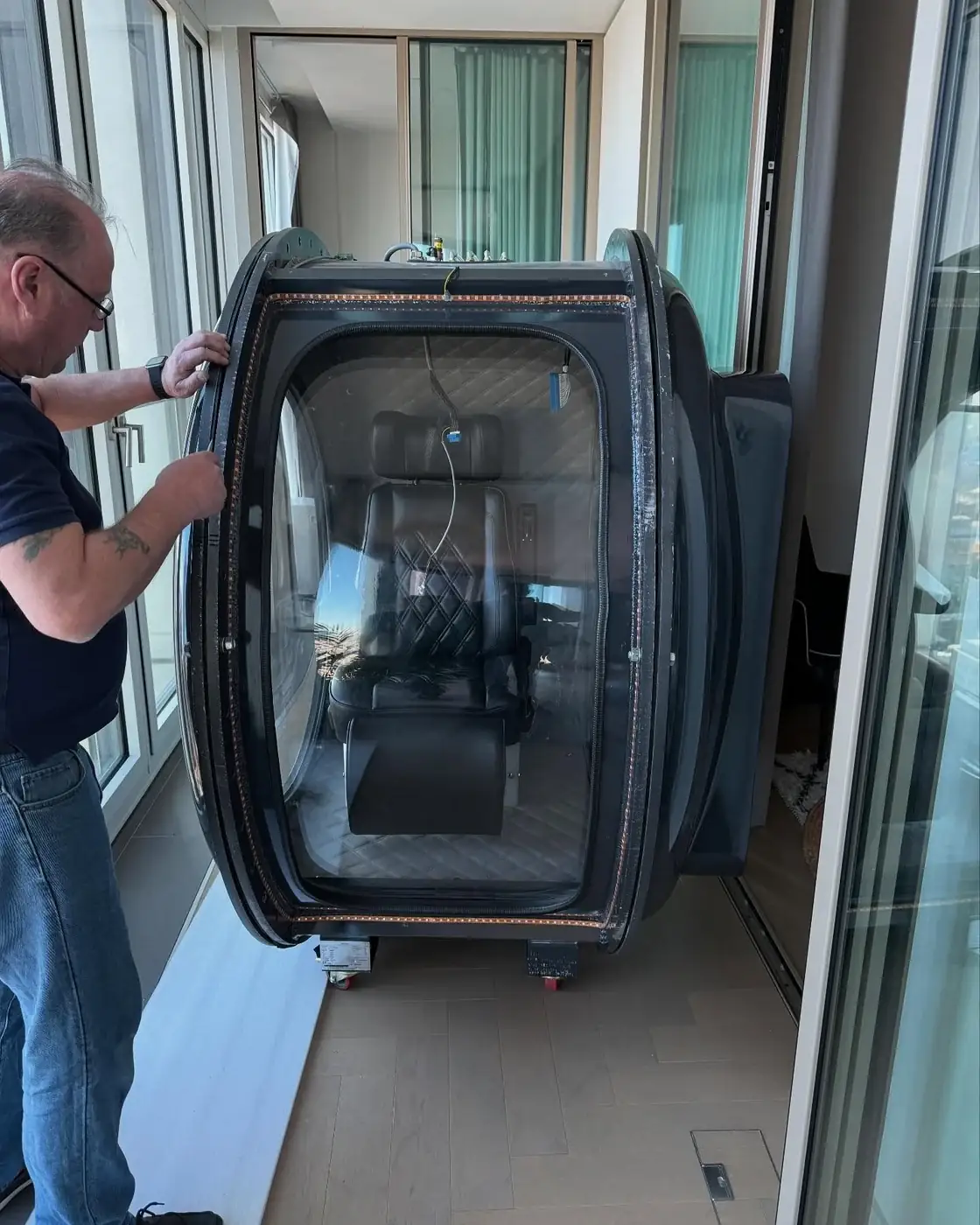 A hyperbaric oxygen chamber standing in a high-rise apartment before being dismantled