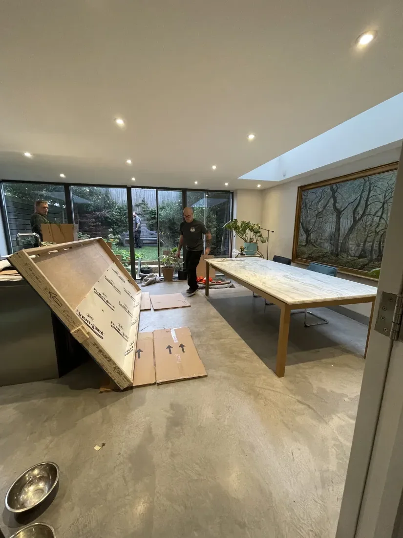 A Wolves Removals crew crating a table with the floor protected