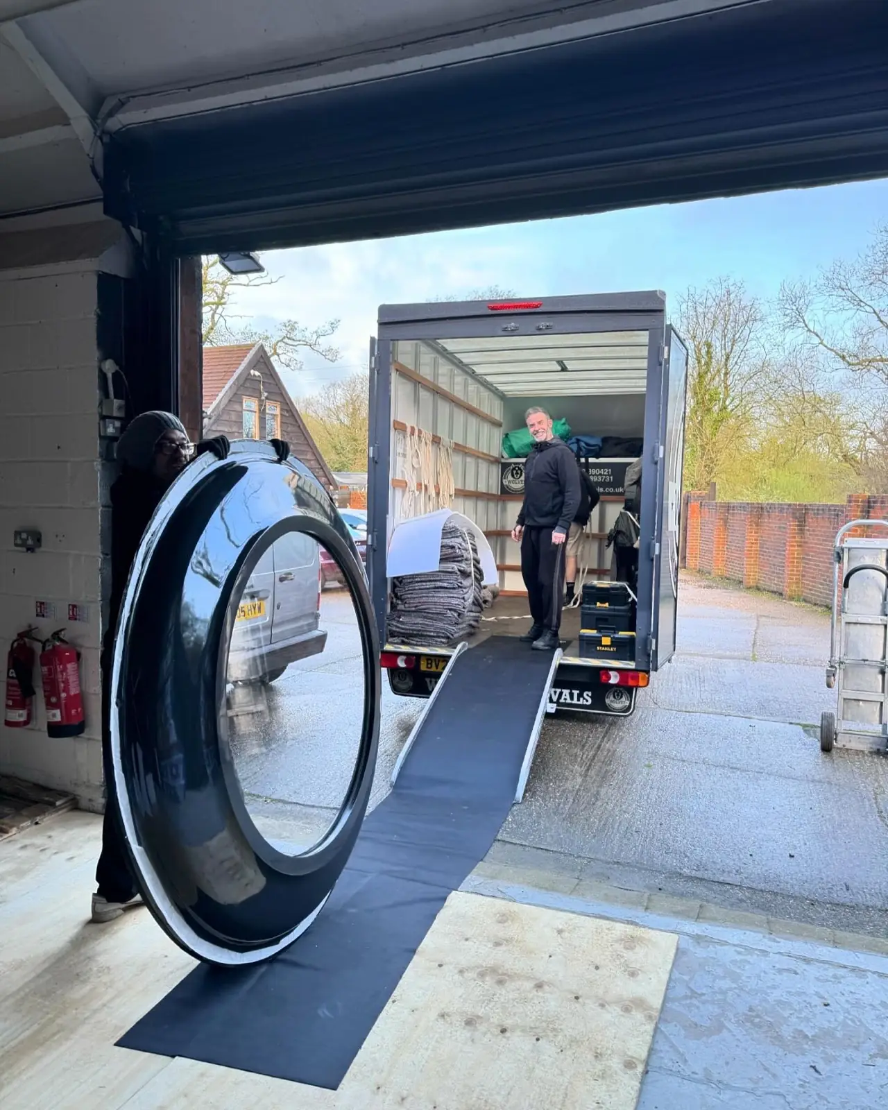 Loading a mirror into the van — a West Sussex removal