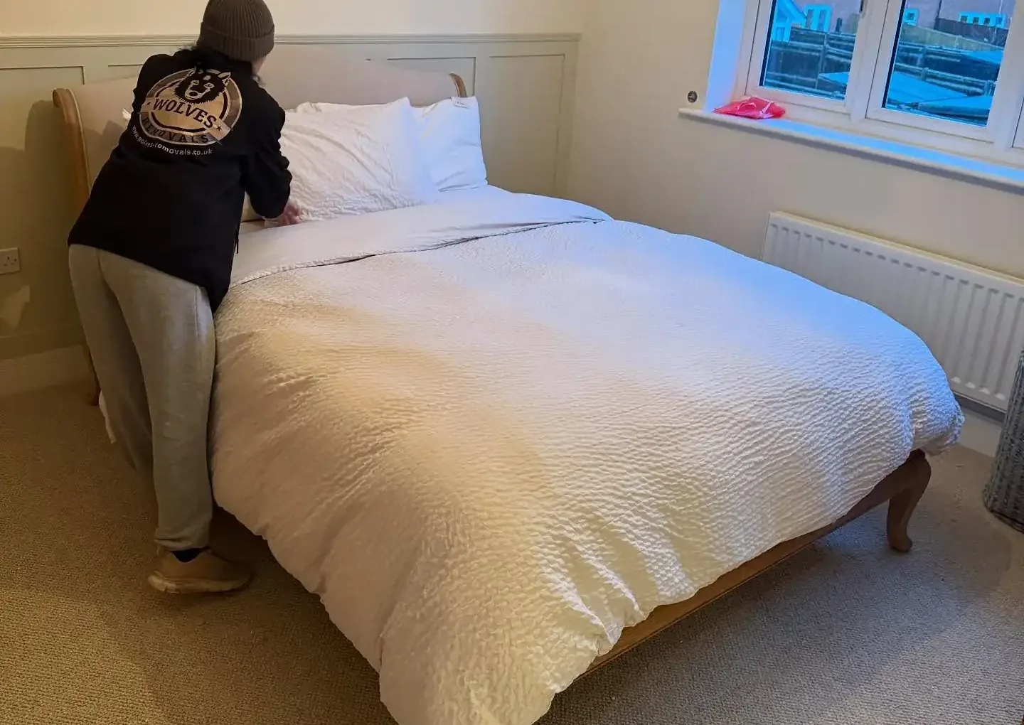 A Wolves Removals crew member making up a bed in its new room after a house move