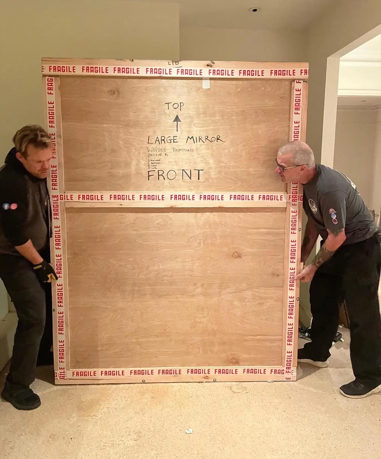 Movers with a fragile mirror crate in Pulborough