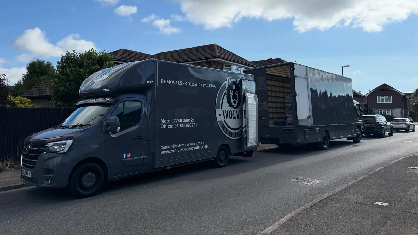 Two Wolves Removals lorries loaded on a suburban street in Angmering on completion day