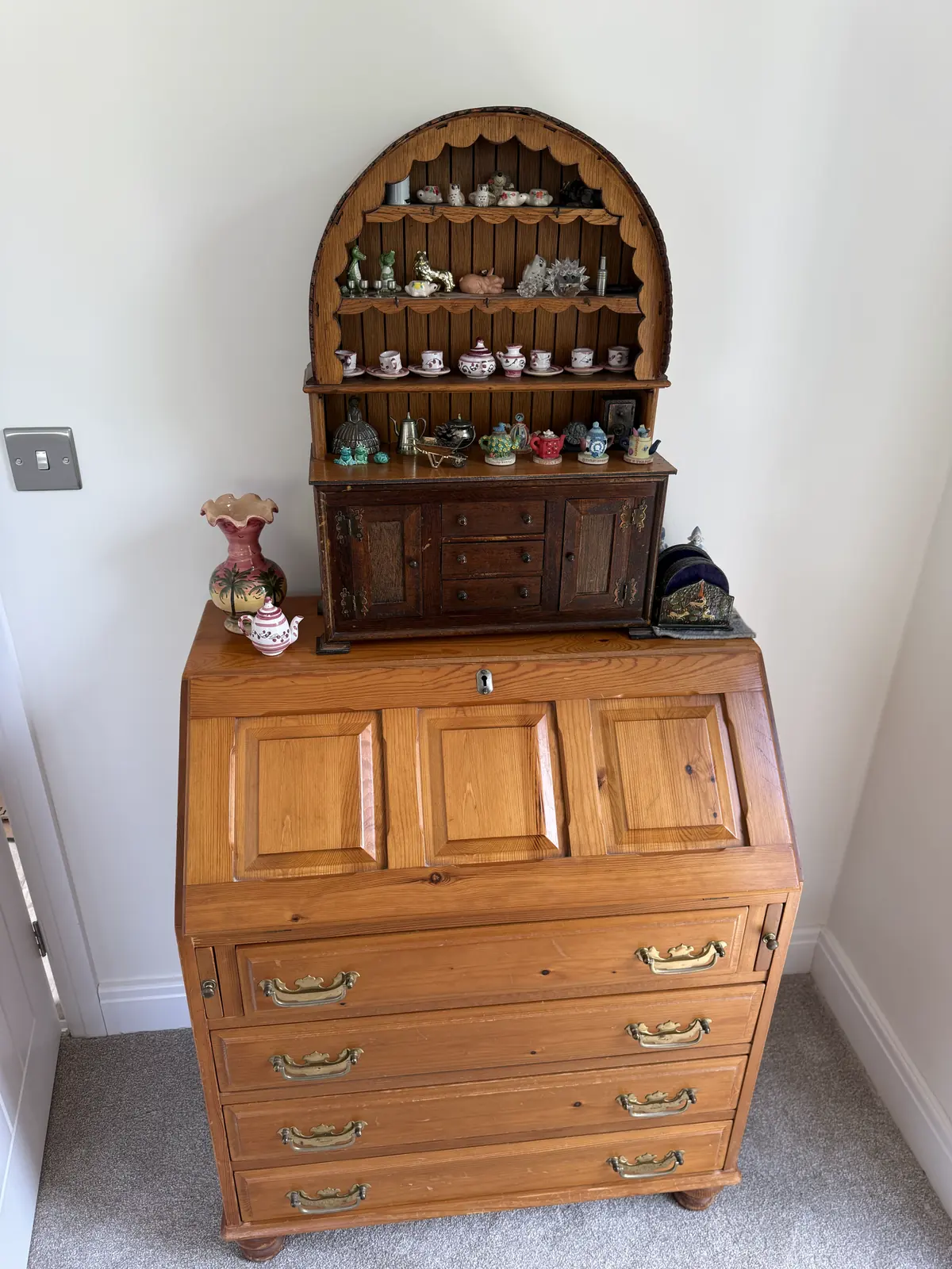 China and ornaments arranged on an antique pine bureau after a full unpack