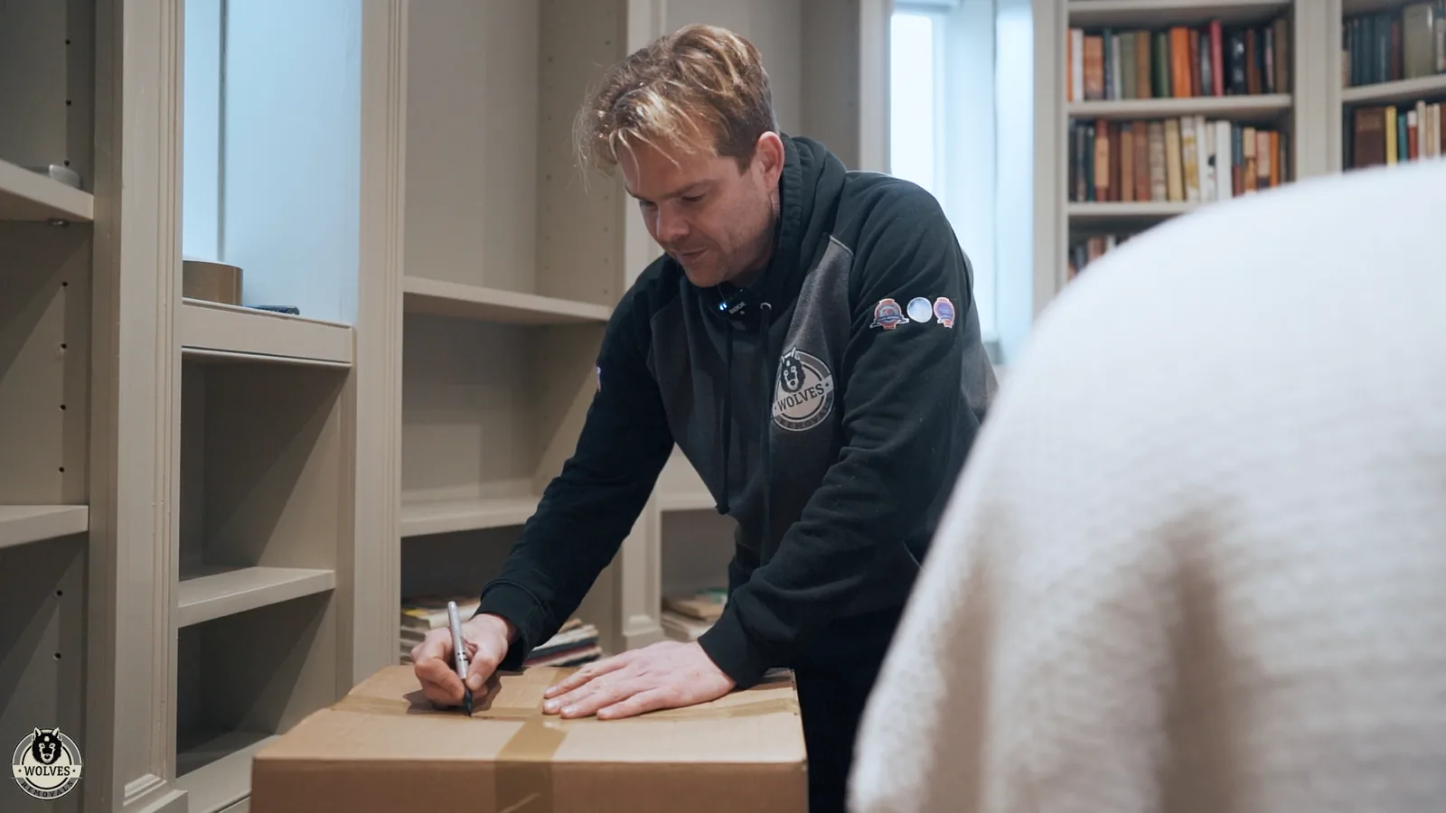 Packing books into moving boxes