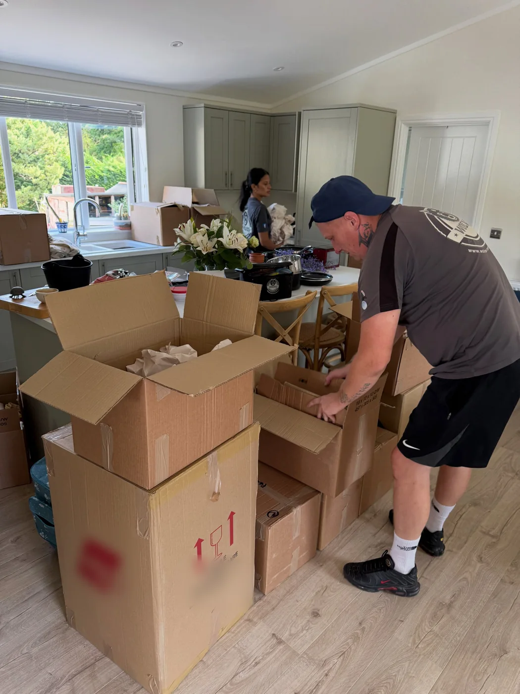 Wolves Removals crew packing china and kitchen items into cartons on moving day