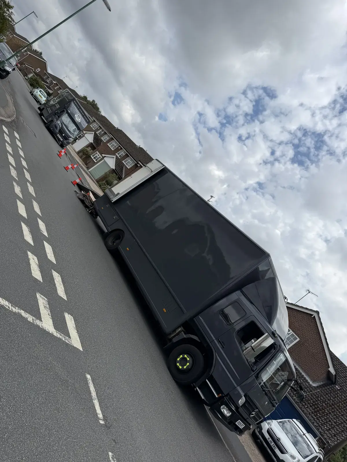 Wolves Removals lorry kerbside on a Storrington street with the branded van beyond it