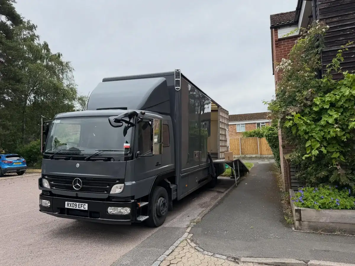 A Wolves Removals lorry with its ramp out on a narrow driveway at a house in Bracknell