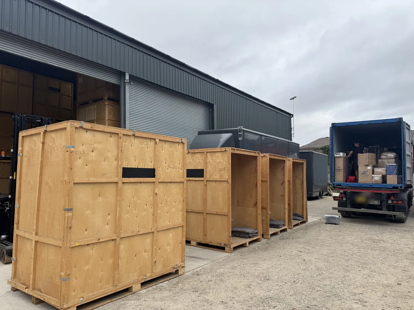 Timber storage containers standing ready in the yard at the Wolves Removals warehouse in Sussex