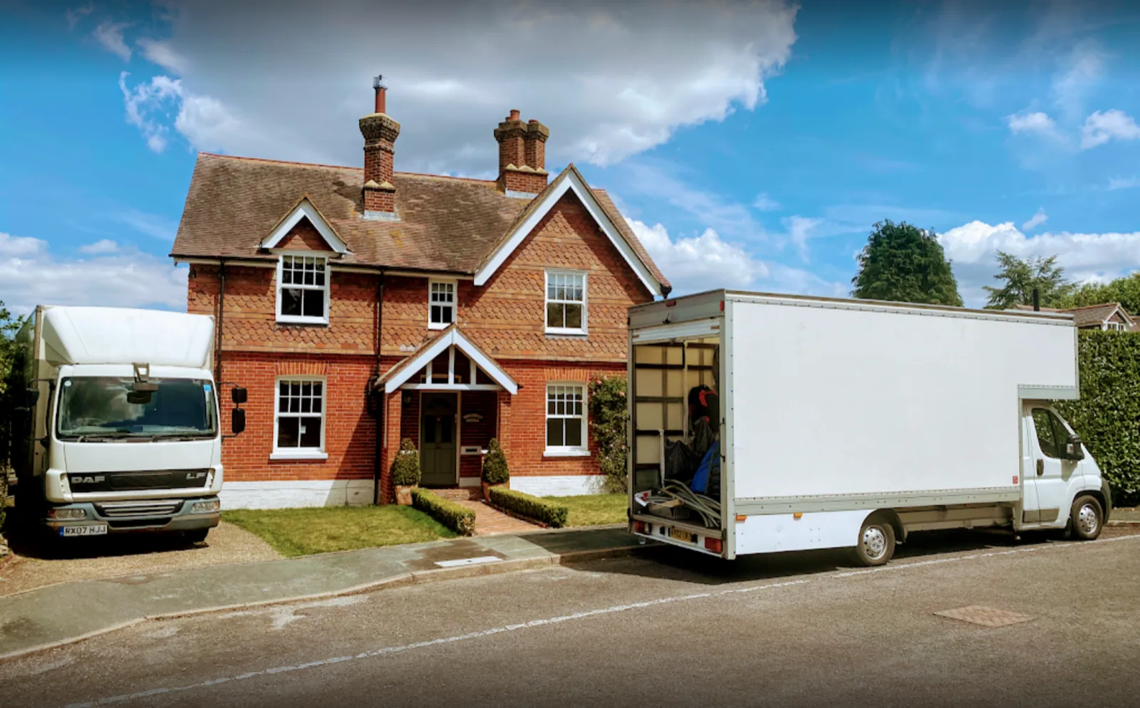 Two vans outside a red-brick house