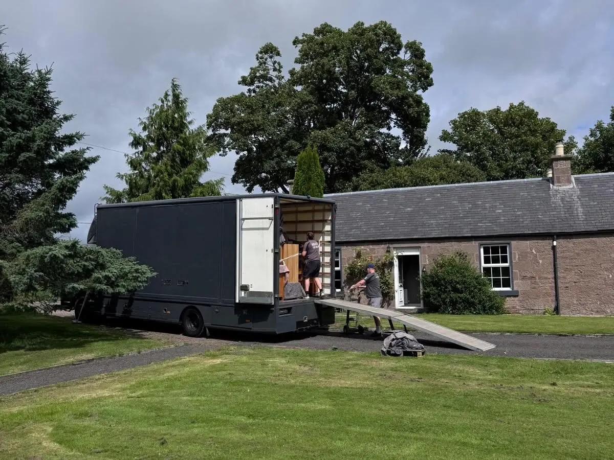 Wolves Removals crew unloading the lorry outside a stone cottage in Perthshire