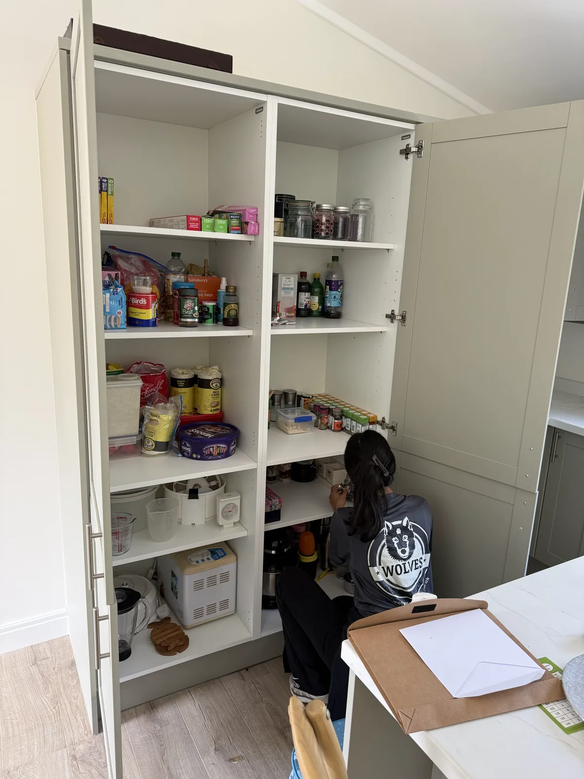 A kitchen larder cupboard unpacked and arranged after a move