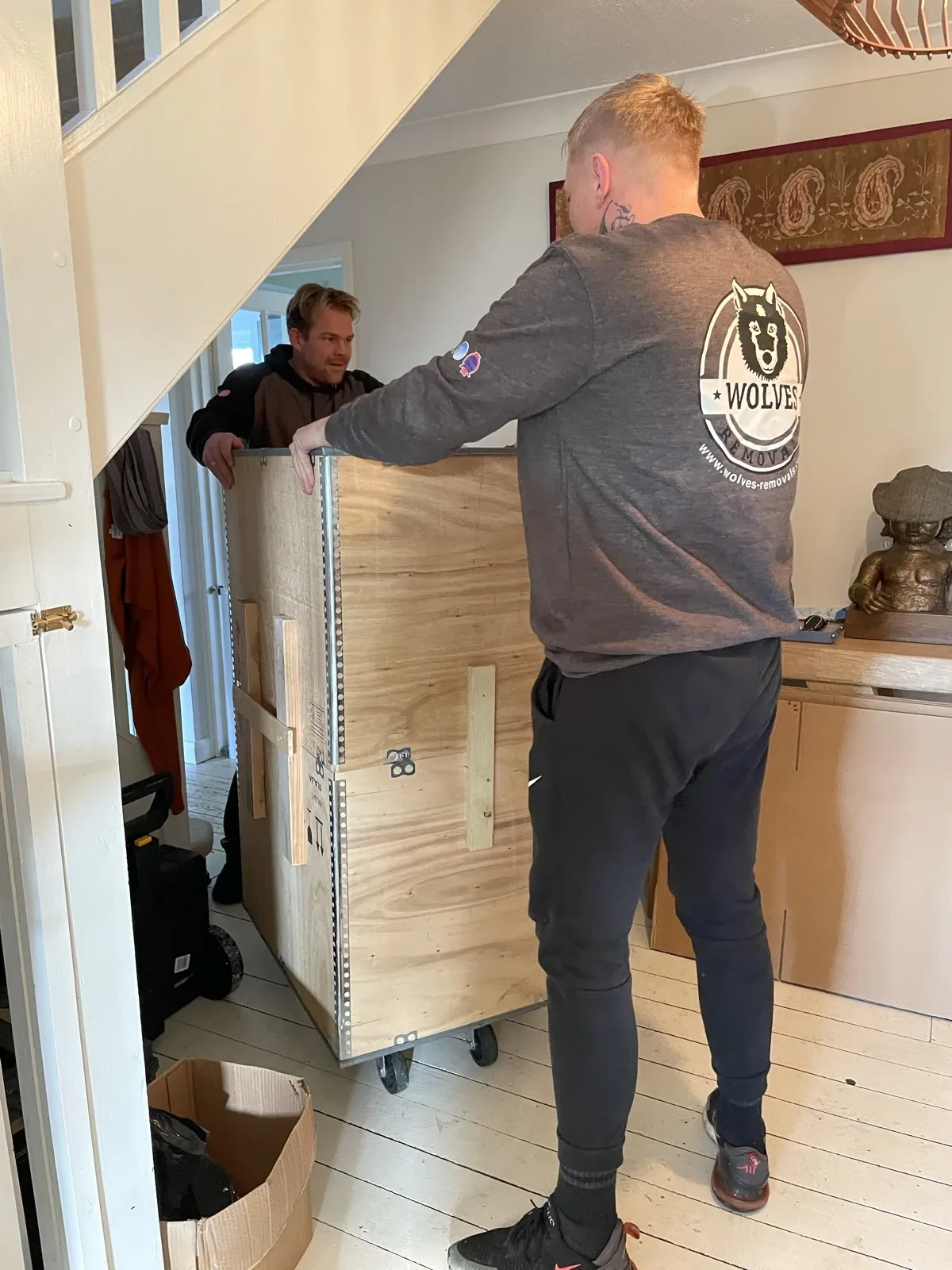 A Wolves Removals export crate being wheeled out on a trolley