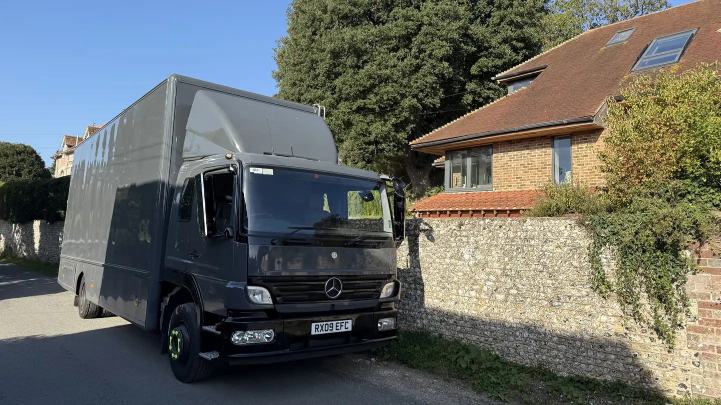 A Wolves Removals lorry on a narrow flint-walled lane at Burpham near Arundel