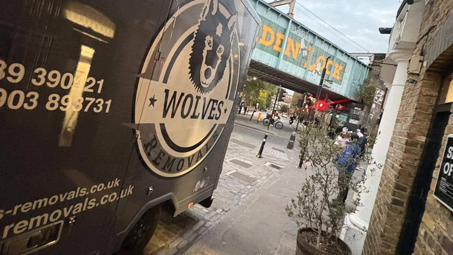 A Wolves Removals lorry parked below the Camden Lock railway bridge in the evening