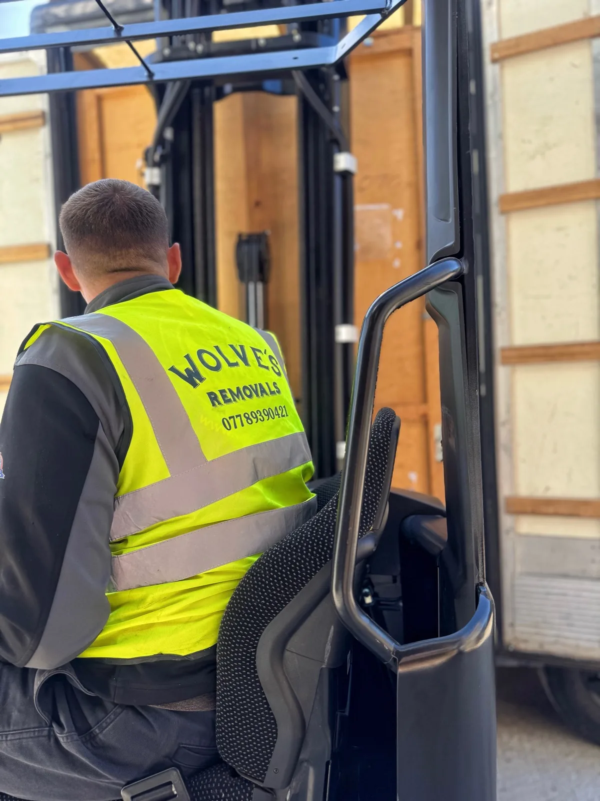 Operator forklifting wooden storage containers for a move in Pulborough, West Sussex