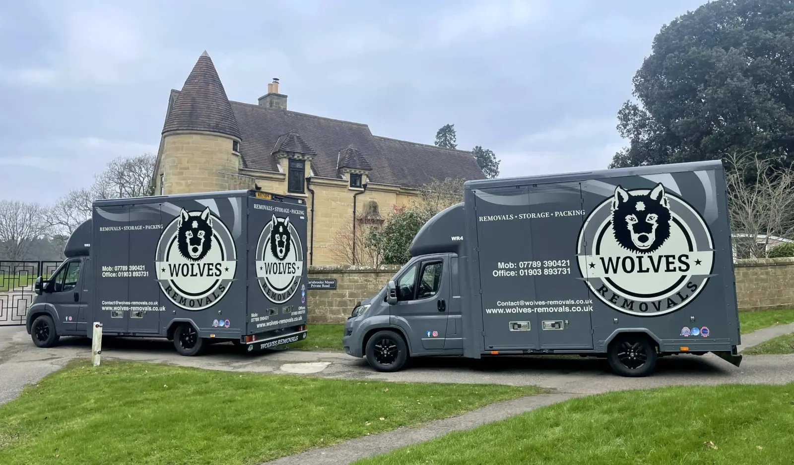 Two Wolves Removals vans outside a house on moving day