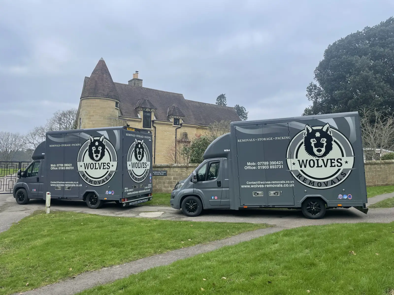 Two Wolves Removals vans outside a manor house