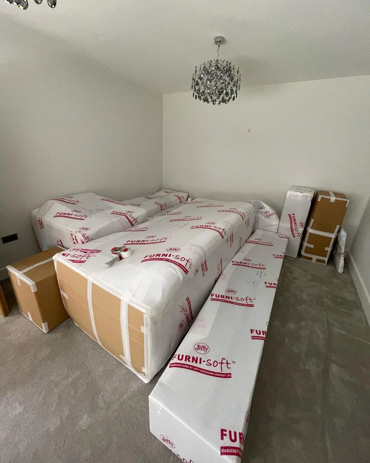 Wrapped furniture and mattresses in a bedroom
