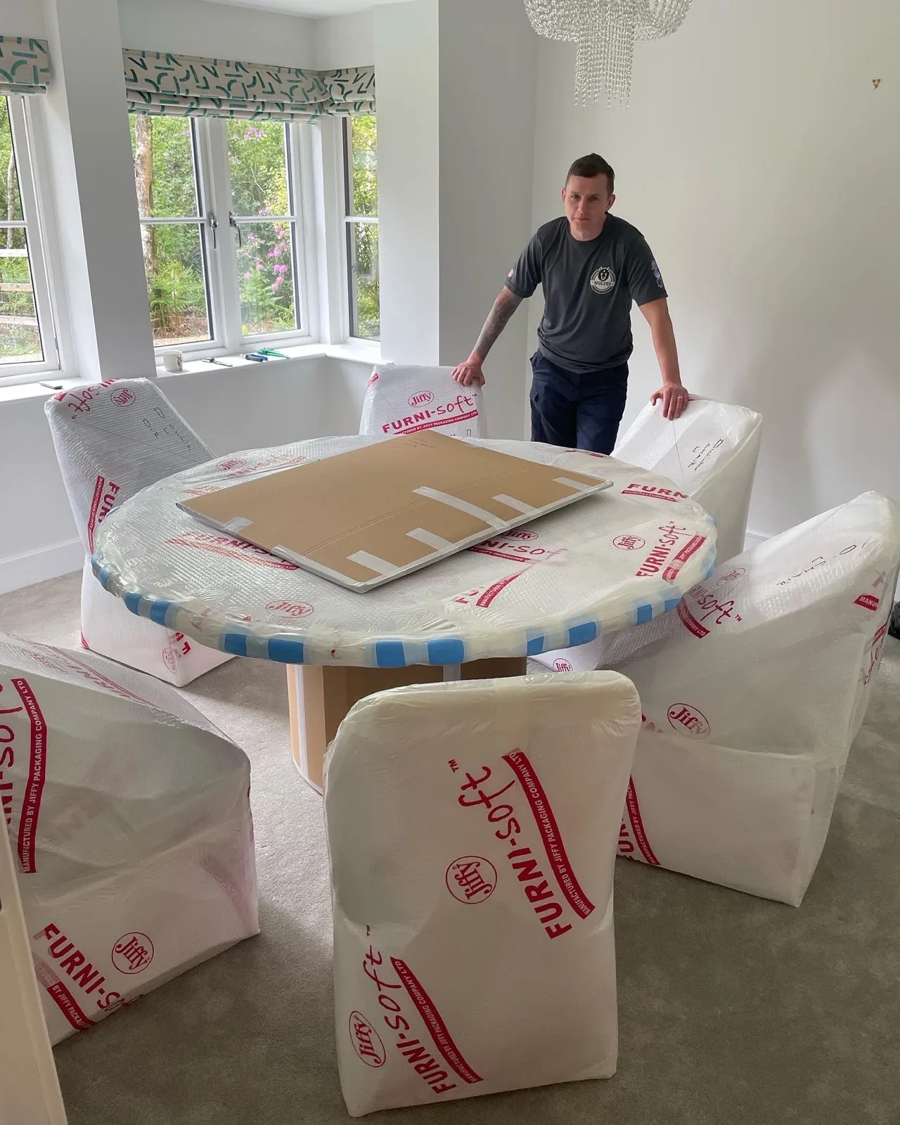 Wrapped furniture and boxes in a living room in Southwater
