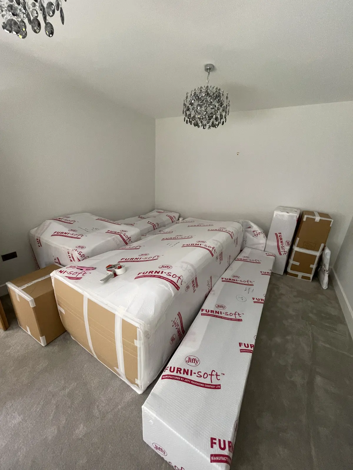 Wrapped furniture in an empty room