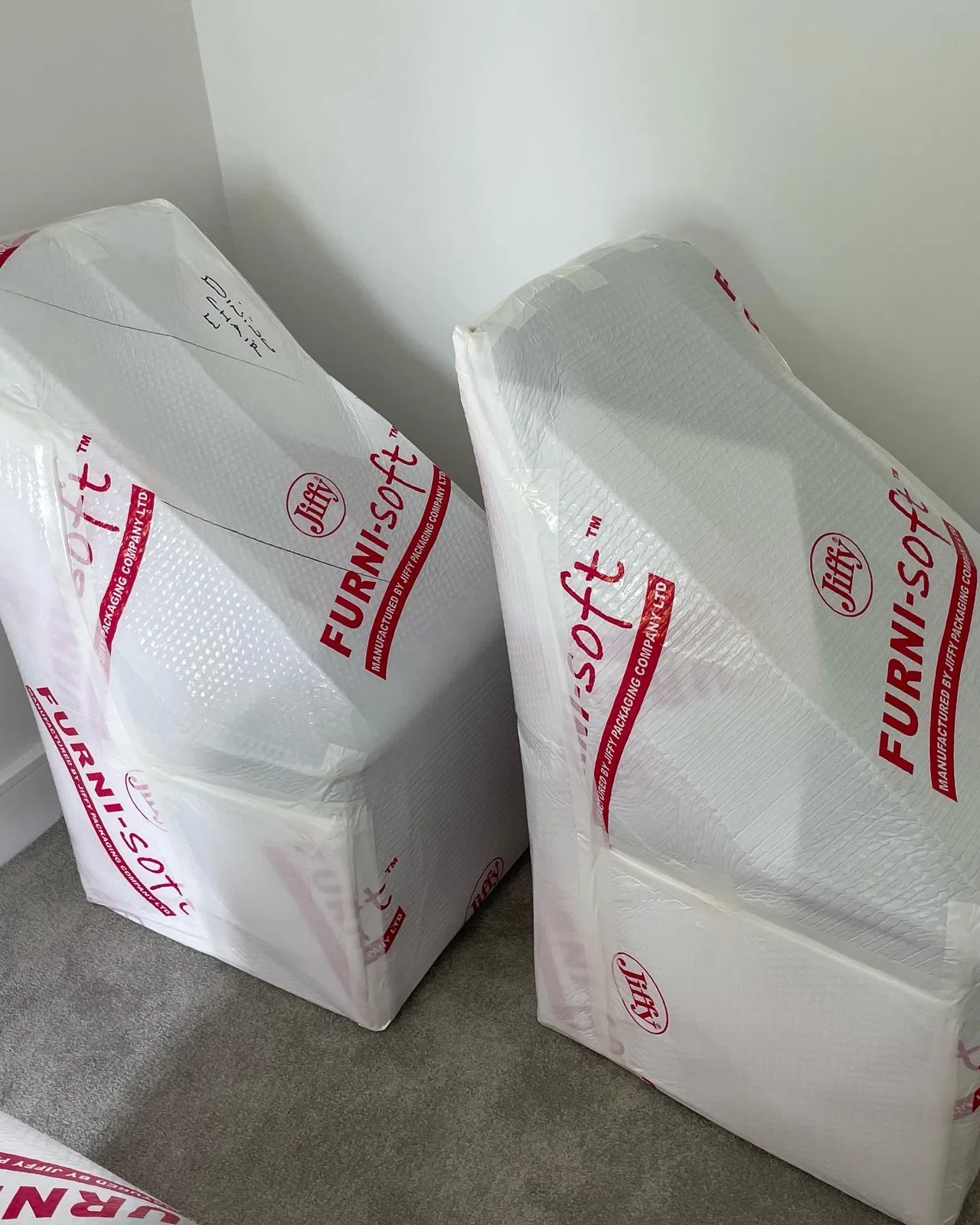 Wrapped furniture in protective covering, stacked
